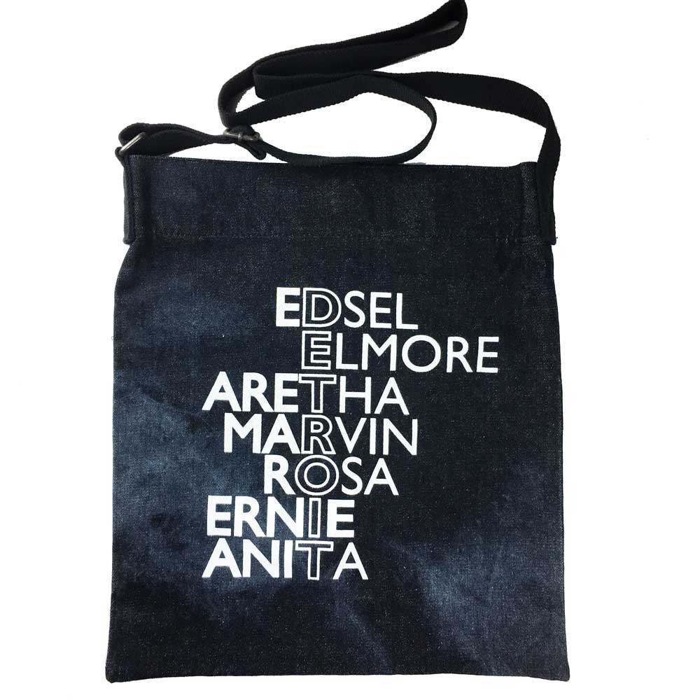 A stylish denim tote with Detroit icons printed in white on a tie dye tote bag